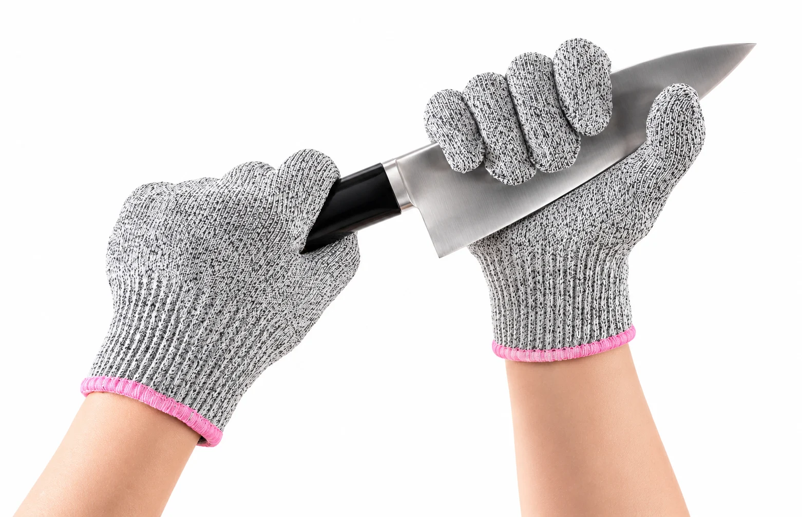 Cut-resistant knitted gloves demonstrating the protective yarn structure around a sharp blade